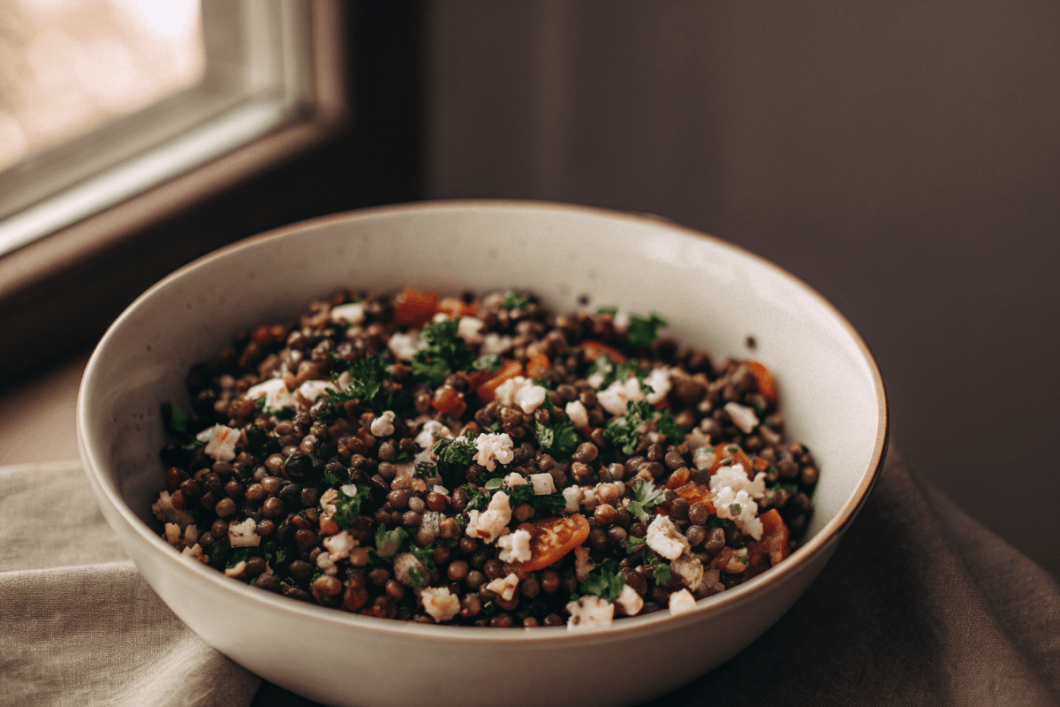 Puy lentil salad with sun-dried tomatoes and goat’s cheese in a bowl